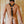 Load image into Gallery viewer, A nude brunette man wearing the black Leather Y Body Harness poses in front of a beige wall, facing away from the camera.
