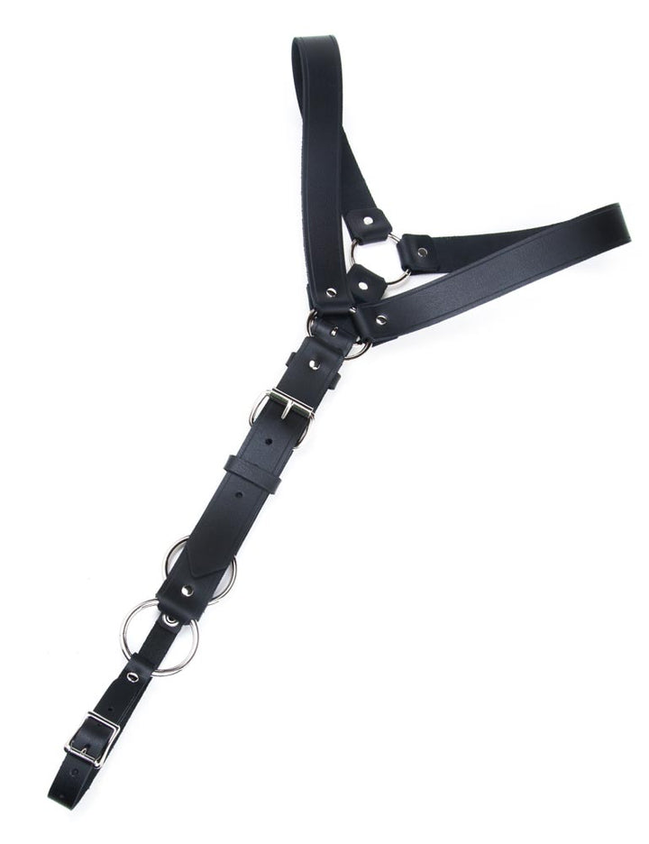 The Leather Y Body Harness with a Metal O-Ring is shown against a blank background. It is shaped like a Y, with shoulder straps connected to one long vertical strap that wraps around the body. The straps are adjustable and have buckles.
