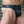 Load image into Gallery viewer, A close-up of a muscular man&#39;s groin area is shown. He wears the black Male Leather Thong, which has a thick black elastic hip bands.

