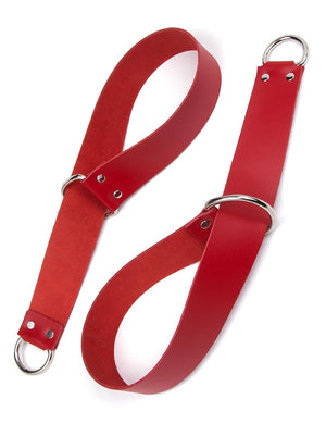 A pair of General Purpose Bondage Straps are shown against a blank background. They are wide strips of red leather with a metal D-ring on each end. The strip has been looped through one of the D-rings to create a cuff shape.