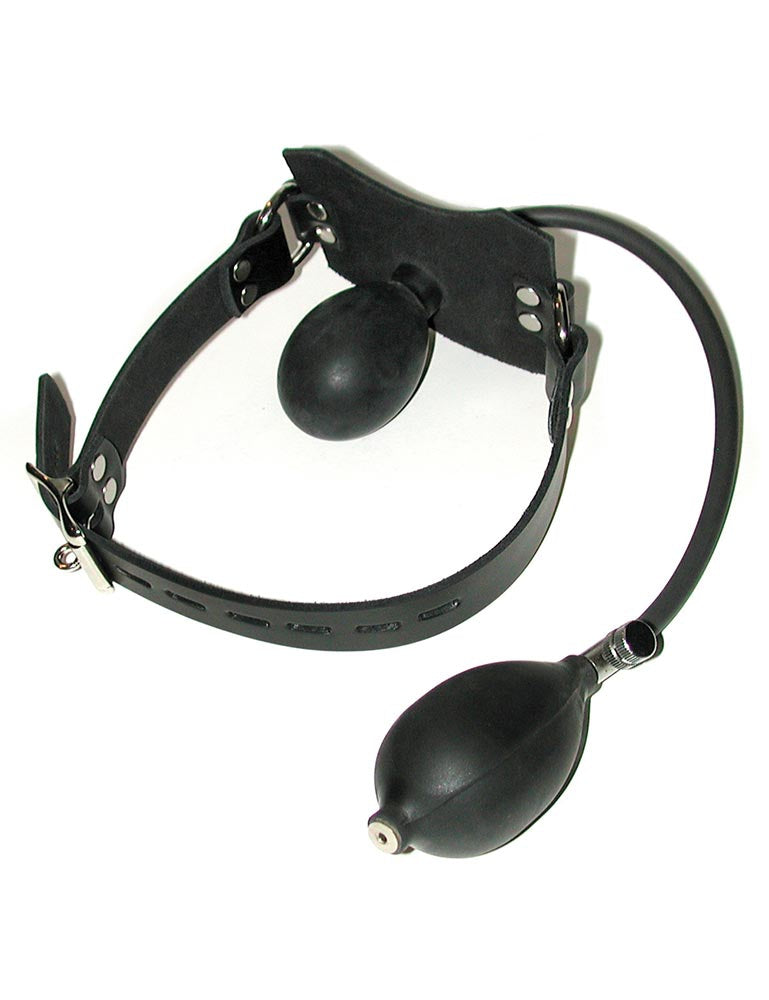 The Lockable Pump Gag is shown against a blank background. The gag has a flat black leather piece in the front of a black leather buckling strap. Behind the leather piece is a black rubber gag attached to a thin tube with a squeeze-bulb pump at the end.