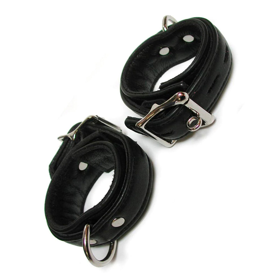 A pair of Premium Garment Leather Wrist Cuffs in black are shown against a blank background. The cuffs are made of black leather with silver hardware. They each have a D-ring and a lockable metal buckle.