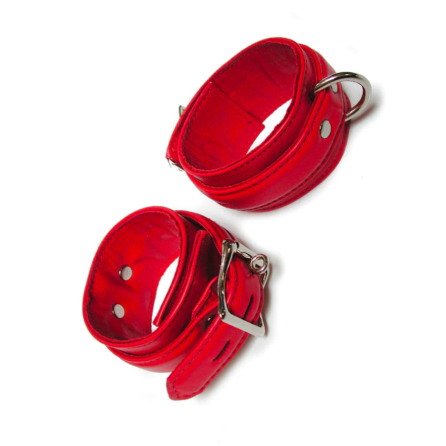 A pair of red Premium Garment Leather Ankle Cuffs are displayed against a blank background. They are made of red leather with silver hardware. Each cuff has one D-ring, and they fasten with lockable buckles.