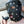 Load image into Gallery viewer, A close-up of a man wearing the Leather Dog Hood with Snap-on Muzzle, Blindfold and Gag and standing outdoors is shown. The muzzle and blindfold have been removed from the gag. His mouth is open and he is holding the gag near it.
