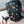 Load image into Gallery viewer, A close-up of a man wearing the Leather Dog Hood with Snap-on Muzzle, Blindfold and Gag and standing outdoors is shown. The muzzle and blindfold have been removed from the gag. His mouth is open and he is holding the gag near it.
