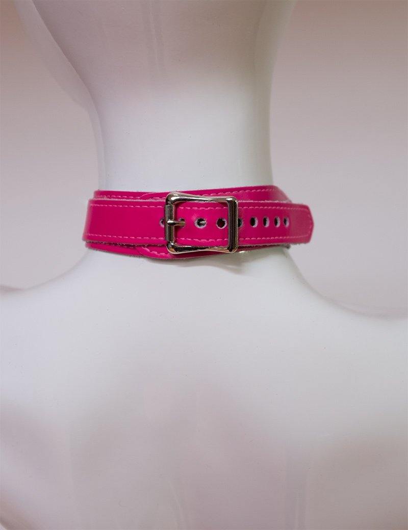 A close-up of the back of the neck of a mannequin wearing the pink Neon Angel Bust Harness is shown. The collar of the harness closes with a silver buckle. 