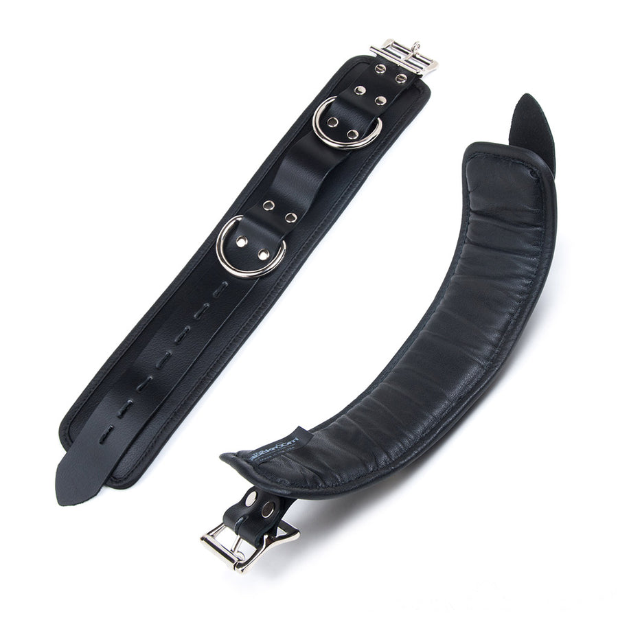 The interior and exterior of the uncuffed Deluxe Padded Leather Wrist Restraints with D-Rings are shown against a blank background. The inside is slightly raised because it is padded.