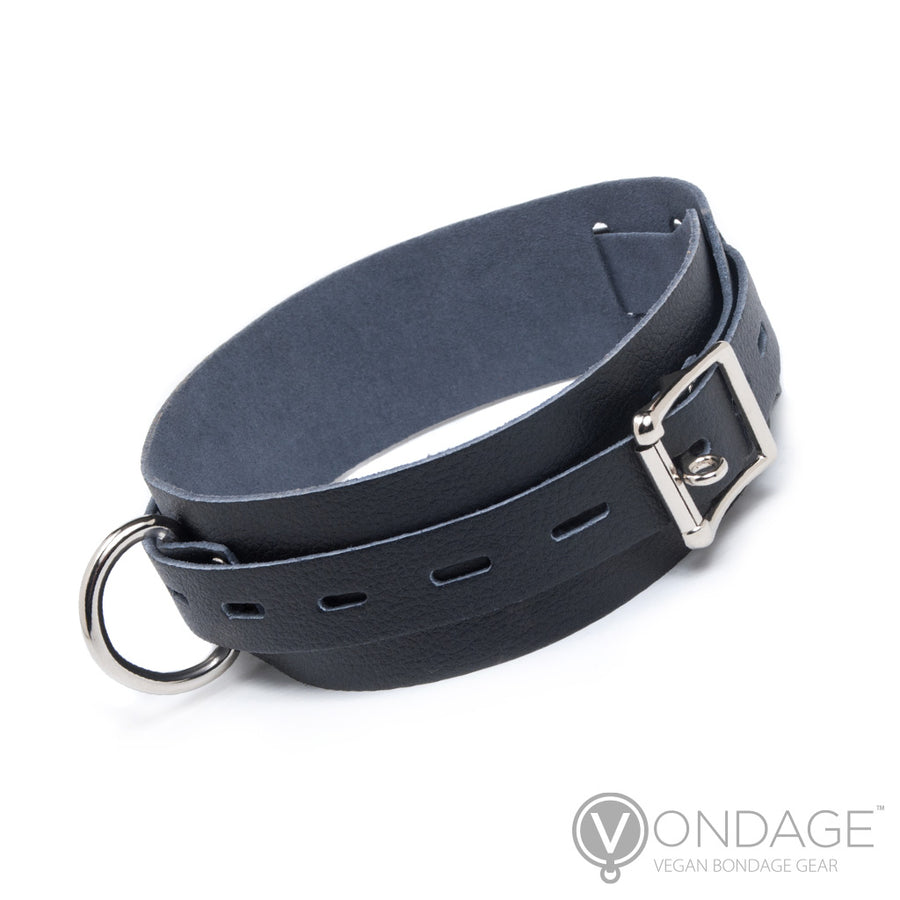 The Vondage Locking/Buckling Collar is shown against a blank background. It is composed of a wide piece of solid black faux leather, with a notched thinner piece wrapped around the wider piece. The hardware is silver metal.