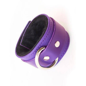 A single Purple Fleece Lined Garment Leather Wrist Cuff is displayed against the background. It is rotated so that the cuff’s D-ring is visible.