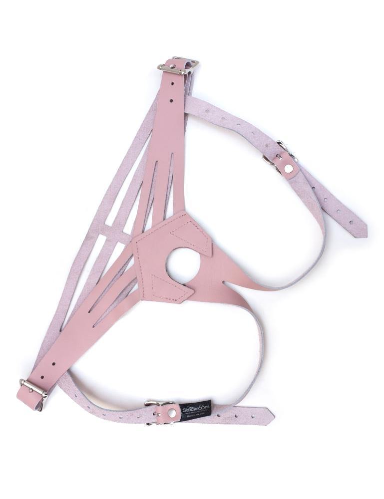 The pink Vanity Strapon Dildo Harness is displayed against a blank background. It is made of light pink leather with silver hardware. There are buckles on each hip and each leg strap.