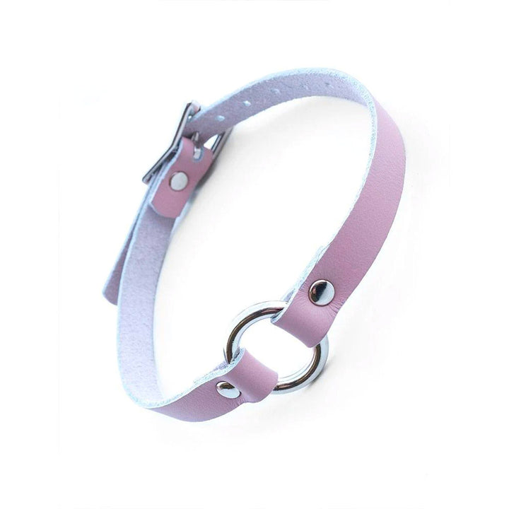 The Stupid Cute O-Ring Leather BDSM Choker is shown against a blank background. The choker is made of light pink leather and metal hardware.