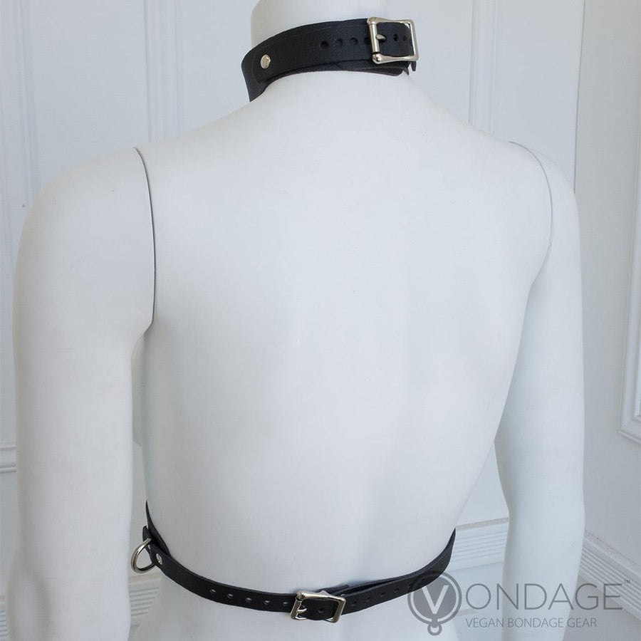 The Vondage Vegan Leather Bust Harness is displayed on a female mannequin from the back. The straps on the neck and around the waist are adjustable and fasten with metal buckles.