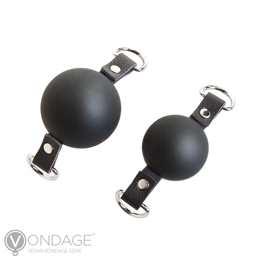 The ball gags for the Vondage Pet Play K9 Muzzle with a Removable Ball Gag are shown against a blank background. The one on the left is large, and the one on the right is small. They are made of matte black silicone.