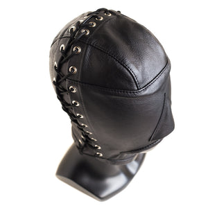 The Open Mouth Leather Bondage Hood is displayed on a mannequin and shown from above against a blank background. The lacing on the hood goes up the side, all the way over the top of the head, and down the other side.