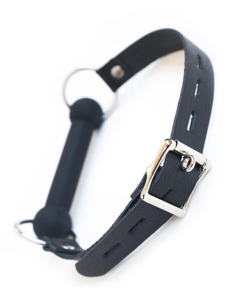 The Kinklab Silicone Bit Gag With A Leather Strap is shown from the back against a blank background, displaying the adjustable metal buckle closure.