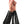 Load image into Gallery viewer, A person&#39;s forearms and fists are shown against a blank background. They are wearing the Lace Up Rubber Gauntlets, made of shiny black latex. The gauntlets cover most of their forearm and have corset-style lacing up the middle.
