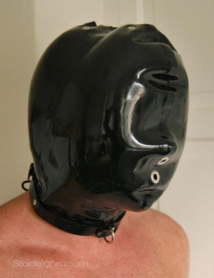 A man is shown standing in front of a blank wall wearing the black Padded Rubber Hood.