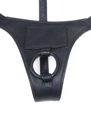 The black leather Buzz Me Tender strap-on harness is shown against a blank background. 
