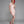 Load image into Gallery viewer, A woman with bright red hair poses in front of a grey backdrop. She wears the Latex Scoop Dress from Syren Latex in baby pink and red high heels. The dress is form-fitting and has a scoop neck and cap sleeves. The hem cuts off at her mid-thigh.
