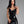 Load image into Gallery viewer, A woman with black hair and red lipstick poses in front of a grey backdrop. She wears the Latex Halter Dress in black from Syren Latex. The dress has a sweetheart neckline and the hem cuts off at her mid-thigh.
