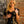Load image into Gallery viewer, A blonde woman poses in front of a brick wall wearing the Ruffly Latex Rubber Heidi Dress by Syren Latex in black. 

