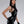 Load image into Gallery viewer, A woman with black hair and red lipstick poses in front of a grey backdrop. She wears the Latex Halter Top with a Zipper in black by Syren Latex. The top has a high neck and a silver zipper down the front. She also wears matching leggings and gloves.
