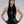 Load image into Gallery viewer, A woman with black hair and red lipstick poses in front of a grey backdrop. She wears the Latex Halter Top with a Zipper in black by Syren Latex. The top has a high neck and a silver zipper down the front. She also wears matching leggings and gloves.
