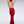 Load image into Gallery viewer, A brunette woman poses in front of a grey background, facing away from the camera and holding her hair up. She wears the red fishtail latex gown from Syren Latex, which has an open back.
