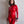 Load image into Gallery viewer, A woman with brown curly hair and red lipstick poses in front of a white wall wearing the Full Body Catsuit with a back zipper in red by Syren Latex. She also wears a black silicone collar and matching cuffs.
