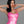 Load image into Gallery viewer, A woman with black hair and red lipstick poses in front of a grey backdrop. She wears the Darla Halter Top by Syren Latex in Pearl Pink. The top is low cut.
