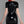 Load image into Gallery viewer, A woman with bright red hair poses in front of a grey backdrop facing away from the camera. She wears the Latex Sweetheart Dress with Short Sleeves by Syren Latex in black. The dress has a zipper up the back.
