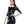 Load image into Gallery viewer, A brunette woman with black lipstick wearing the Wednesday dress by Syren Latex in black poses in front of a blank background. The dress has a white peter pan collar with black latex ribbons and white cuffs on the sleeves. 
