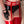Load image into Gallery viewer, A close-up of a woman&#39;s hips and thighs is shown. She wears black latex panties and red latex stockings, which are held up by the red Latex Cage Garter. The waistband of the garter is made of three strips of latex with a silver zipper in the center.

